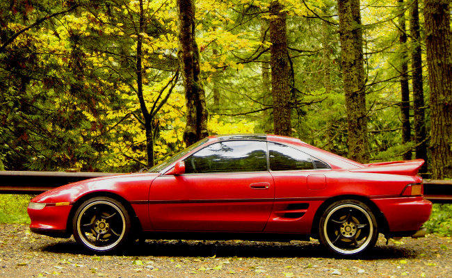 contrasting red MR2 with green natural background